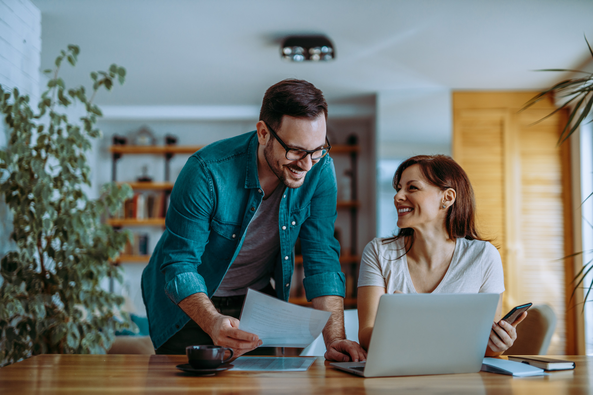 Portrait of successful smiling small business owners at cozy office.